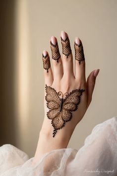 a woman's hand with hendix on it and a butterfly drawn on the palm