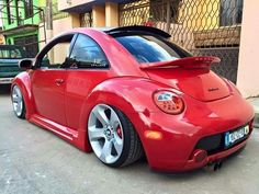 a red car parked in front of a building