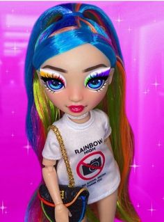 a doll with blue and green hair holding a handbag in front of a pink background