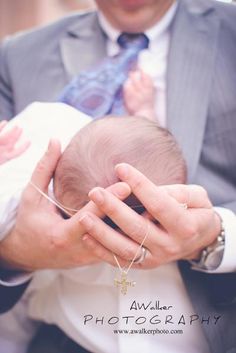 a man holding a baby in his hands