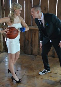 a man in a suit and tie holding a basketball next to a woman in a white dress