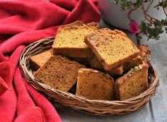 a basket filled with slices of bread next to a potted plant