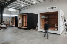 a man standing inside of a small building