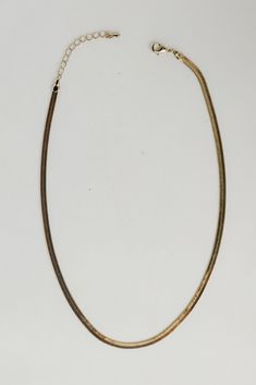 It's easy to collect compliments on your ensemble when you style it with the Monica Gold Snake Chain Necklace! This cute necklace features a simple gold snake chain. Style the Monica Necklace with any outfit to instantly upgrade your look! Gold Plated Snake Chain Lobster Clasp + Extender One Size | Length 7.5” + 3" Extender Minimalist Yellow Gold-plated Snake Chain Necklace, Adjustable Gold-plated Snake Chain Necklace, Yellow Gold Brass Snake Chain Necklaces, Minimalist Yellow Gold Snake-shaped Necklace, Gold Snake-shaped Metal Necklace, Gold Snake Chain, Snake Chain Necklace, Upgrade Your Look, Chic Necklace