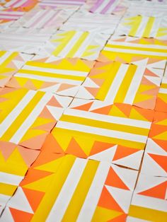 an orange, yellow and white pattern is shown on the ground with strips of paper