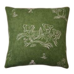 a green pillow with white designs on it