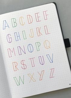 an open notebook with colorful letters on it