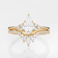 an engagement ring with a pear shaped cut diamond surrounded by smaller round diamonds on the band