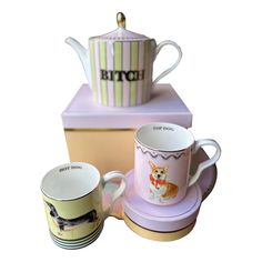 three coffee cups and saucers are sitting next to each other on top of a box