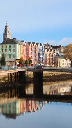 a bridge over a body of water with buildings in the background