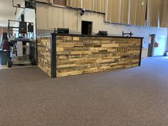 a reception area in an office building with wood paneling on the front and back