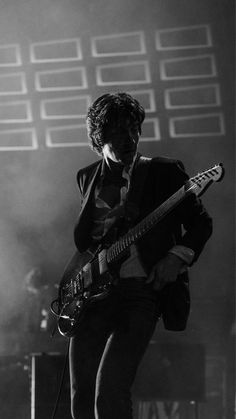 black and white photograph of a man playing an electric guitar