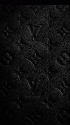 the back side of a black louis vuitton bag with monograms on it