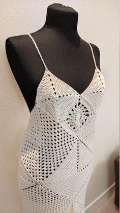 a white crocheted dress on a mannequin