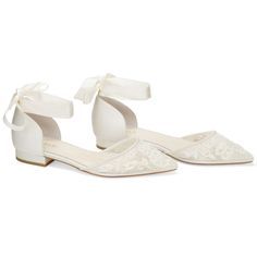 a pair of women's white shoes with bows on the toe and lace detailing