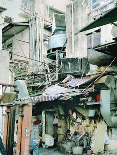 an alleyway with lots of junk and old buildings