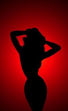 the silhouette of a woman with her hands on her head in front of a red background