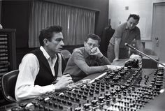 two men sitting in front of a mixing desk