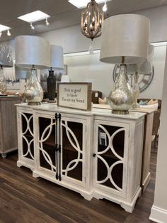 the inside of a furniture store with two lamps on each side and an open cabinet