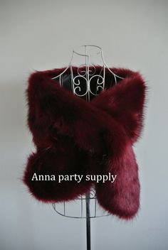 a red fur stole sitting on top of a mannequin headdress with the words, ama party supply