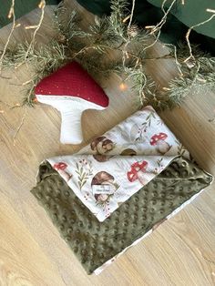 a mushroom shaped object sitting on top of a wooden floor next to a christmas tree