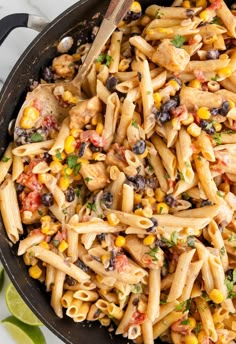 a skillet filled with pasta and vegetables