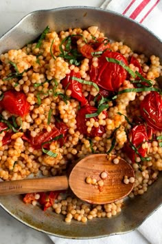 a skillet filled with corn and tomatoes