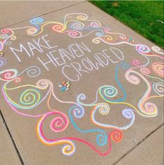 a sidewalk with chalk writing on it that says make heaven proud and swirls in the air