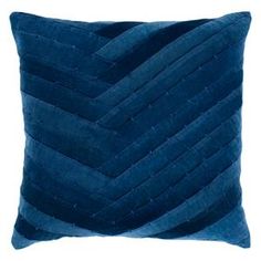 a blue velvet pillow with wavy lines on the front and back, against a white background