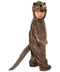 a little boy in a costume that is wearing a cat suit and standing on one leg