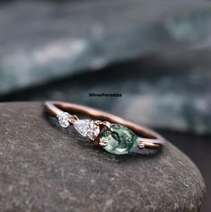 a close up of a ring on top of a rock