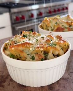 two white casserole dishes filled with lasagna and broccoli covered in cheese