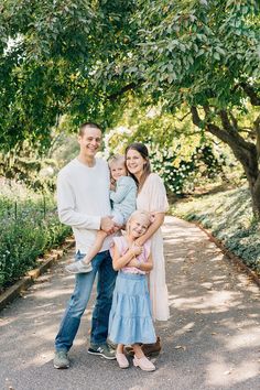 a family poses for a photo under a tree