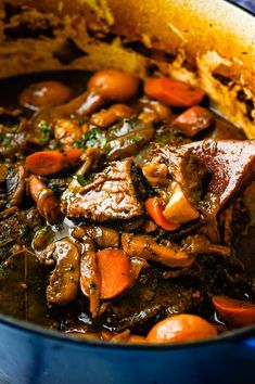 a pot full of stew with carrots and meat