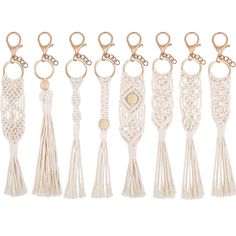 a row of tasselled keychains with gold tone metal clasps on each side