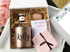 a gift box containing a personalized coffee mug, notepad, and napkins