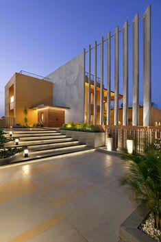 an outdoor area with steps and lights at night time, leading up to the building's entrance