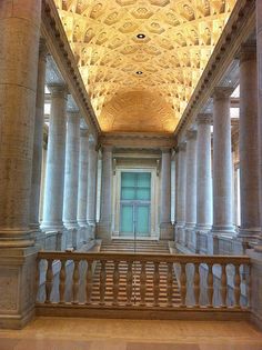 the inside of a building with columns and arches