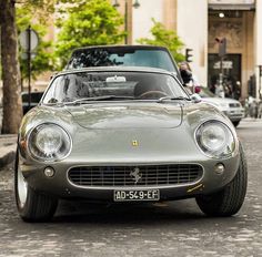 a silver sports car parked on the street