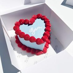 a heart shaped cake in a white box