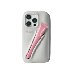 an iphone case with a pink toothbrush on the back and its holder attached to it