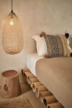 a room with a bed, lamp and rugs on the floor next to it