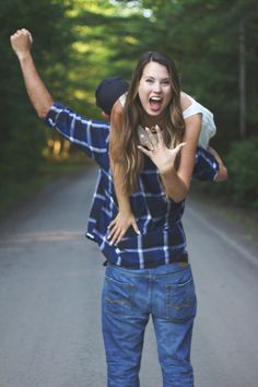 a young woman is riding on the back of a man's shoulders as he holds her