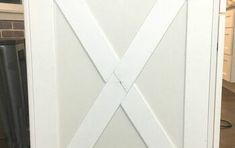 a white barn door with the cross cut out