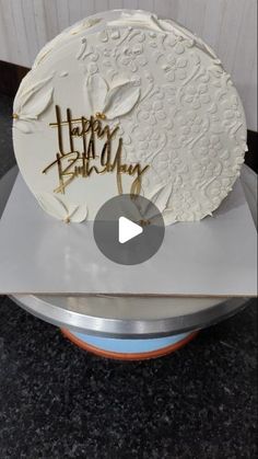 a white cake sitting on top of a metal pan covered in frosting and writing