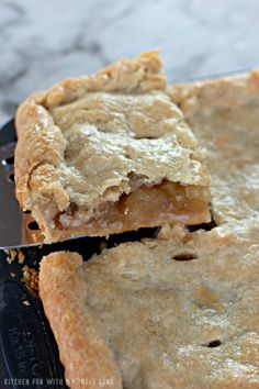 two pieces of pie sitting on top of a cutting board