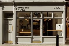 a store front with the door open on a city street