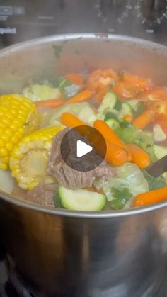 a pot filled with vegetables and meat on top of a stove