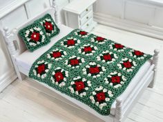 a crocheted bed with two pillows on it