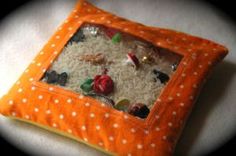 an orange and white square pillow with small objects in it